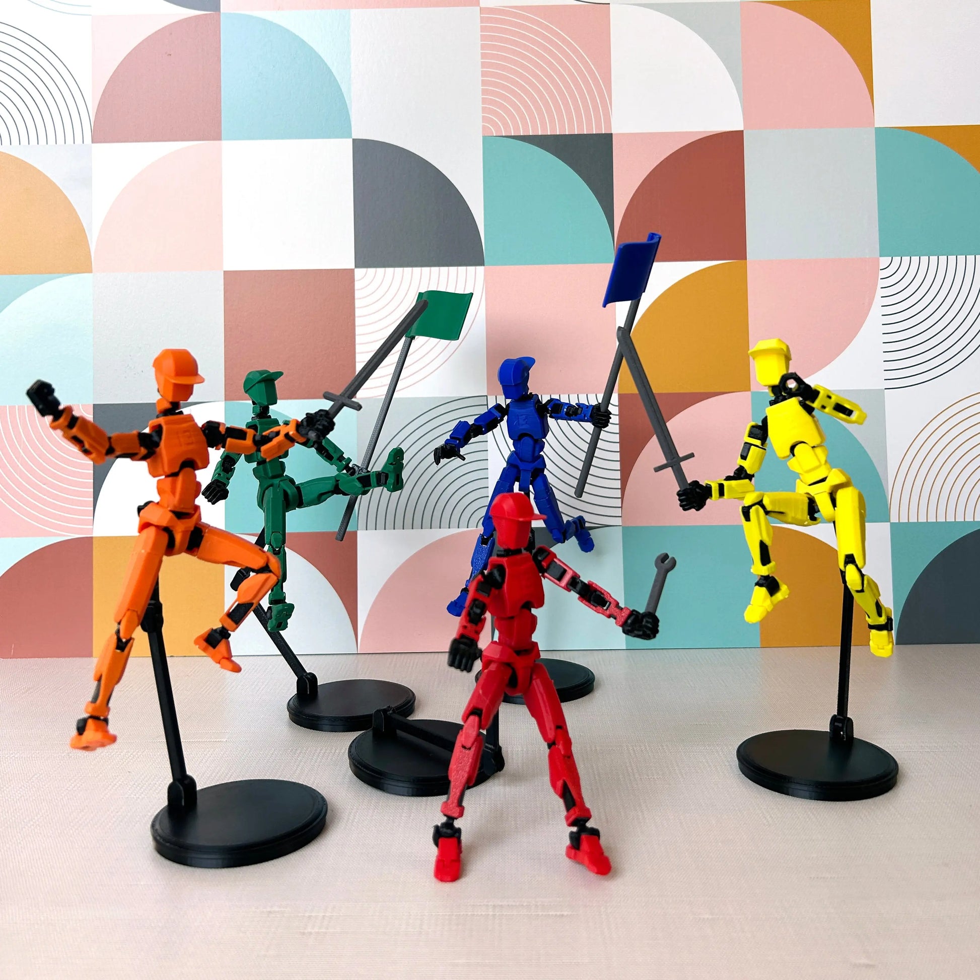 Orange, red, blue, green, and yellow Dummy 13's in different posed positions