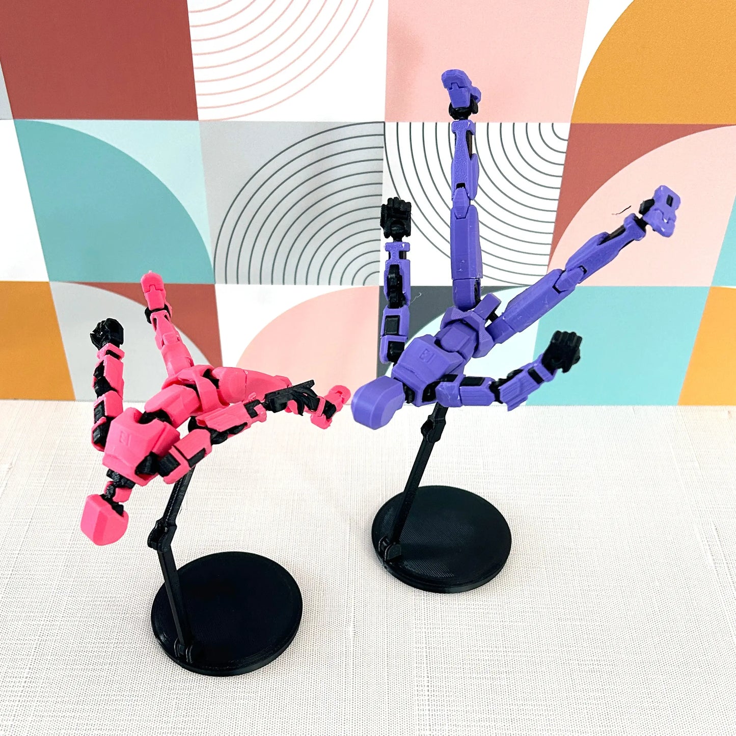 pink and purple dummy 13 3d Printed action figures on black display stands